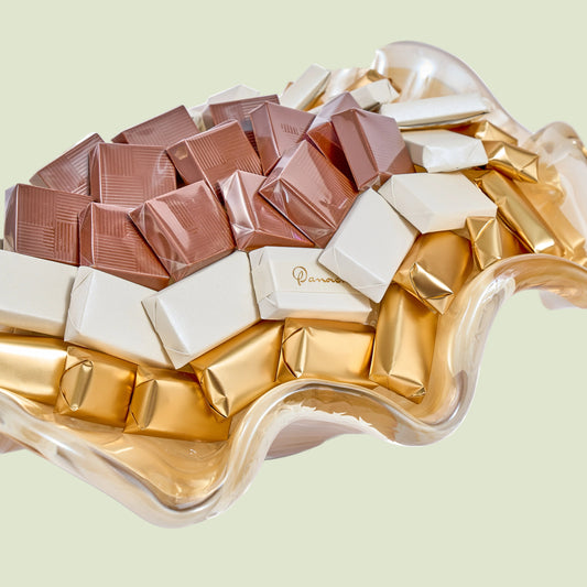 Murano crystal wavy dish close-up showing rose gold white and gold wrapped chocolates detail