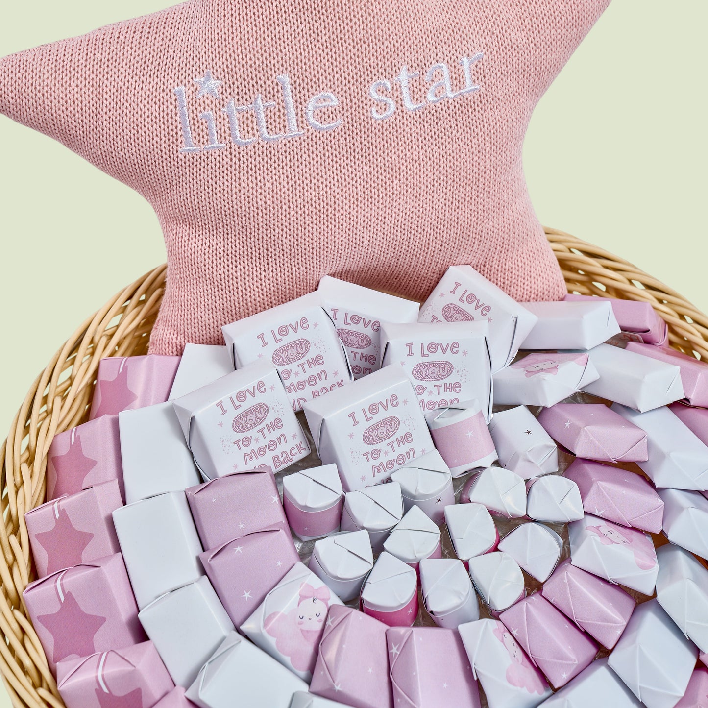 Pink and white dragées assortment in baby girl star arrangement close-up